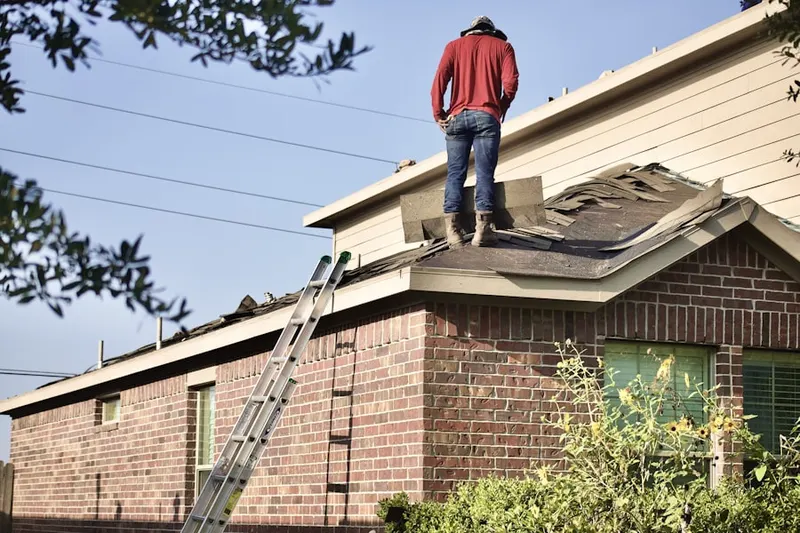 Professional roofer working on a residential roof in Rockwall